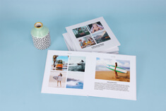 High-quality photo book, lay-flat hardcover, square format, open book view